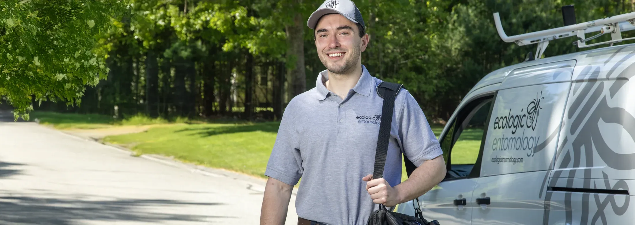 pest technician standing next to van