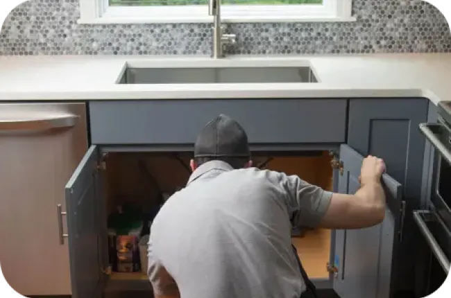 technician inspecting cabinets