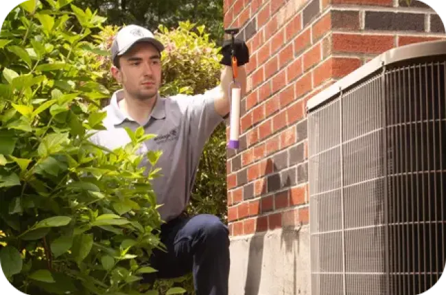 technician inspecting termite bait